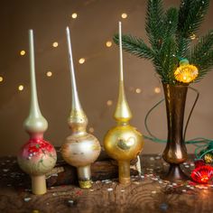 there are three vases with candles in them on the table next to each other