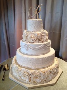 a three tiered wedding cake sitting on top of a table