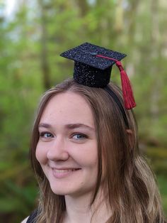 Black Glitter Graduation Caps attached to elastic or a black hard headband.  Choose a tassel color for your cap!   Our party hats and crowns are attached to a comfortable  elastic and meant to be worn around the back of the head, behind the ears. Tilt to the side for a fun, whimsical look! LITTLE BLUE OLIVE SHOP CROWNS and HATS are the perfect accessory for birthday celebrations, memorable photo shoots and every day fun for dress up. Hats are hand crafted of a high quality, non-shed glitter. Adjustable Black Graduation Cap Topper As A Gift, Black Graduation Cap Accessories, Adjustable Black Graduation Cap Topper, Adjustable Black Hats For Graduation Gift, Black Adjustable Hats For Graduation Gift, Adjustable Black Hat For Graduation Gift, Adjustable Black Hat For Graduation, Black Adjustable Hat For Graduation, Adjustable Cap For Graduation Party