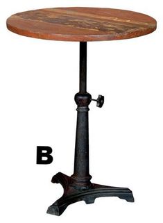 an old fashioned wooden table with metal legs and a small round top on the base