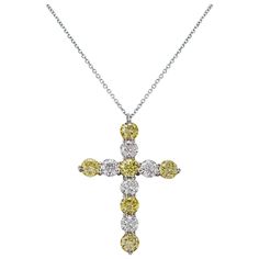 A classic pendant necklace, showcasing six fancy yellow diamonds spaced by white round brilliant cut diamonds, set in an elegant shared prong design. Diamonds weigh 4.32 carats total. Finely made with 18K white gold and platinum.  Roman Malakov is a custom house, specializing in creating anything you can imagine. If you would like to receive a special quote on a custom piece, please message or call us. Classic Pendant Necklace, Diamond Cross Necklace, Yellow Diamonds, Fancy Yellow Diamond, Diamond Cross Pendants, Diamond Cross, Cross Pendant Necklace, Yellow Diamond, Brilliant Diamond