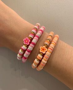 three different bracelets with flowers on them