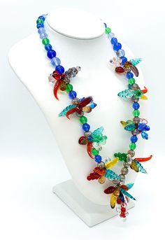 "Vintage Mid Century Tutti Fruitti Tropicana Molded Art Glass Bead Necklace 18\" Up for offer is a unique vintage mid century tutti fruitti tropicana molded art glass bead necklace. This necklace is sure to make a statement with its rainbow colored, slightly iridescent beads and molded art glass grape cluster, leaf, heart, chili pepper and teardrop shaped beads. This necklace features a hook clasp. Necklace is not marked. Measurements Length: 18\" inches Round Beads: 7.5mm-8.5mm Weight: 103 g Co Handmade Multicolor Murano Glass Necklaces, Multicolor Murano Glass Beaded Necklace, Vintage Multicolor Glass Necklaces, Handmade Multicolor Murano Glass Necklace, Unique Multicolor Murano Glass Necklaces, Bali Jewelry, Thick Chain Necklace, Silver Jewelry Necklace, Vintage Art Glass