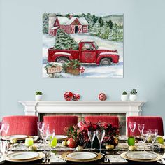 a table set for christmas with plates and place settings in front of the fire place