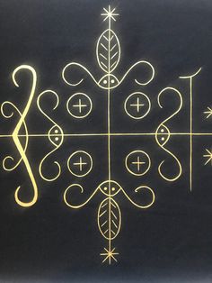 a black background with gold and white designs on it