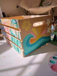 a painted wooden box sitting on top of a table