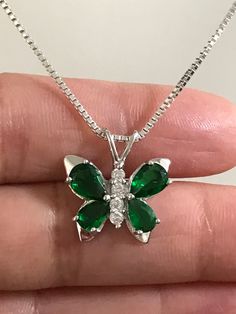 Sterling Silver Emerald CZ Butterfly Necklace Emerald is the birthstone for May. This makes a perfect gift for those loved ones born in May. Metal: All components are made from solid .925 Sterling Silver Stone: Cubic Zirconia Measurement: pendant height is 18mm including bail and 17mm at widest part Choose Chain Length At Checkout You can find other CZ and Birthstone Jewelry in my shop here https://www.etsy.com/shop/LinksAndStones?ref=seller-platform-mcnav&section_id=24399452 Please feel fre Green Butterfly Necklace, Green And Silver Jewellery, Emerald Butterfly, Butterfly Necklace Silver, Quinceanera Jewelry, Born In May, Necklace Emerald, Prom Inspo, Necklace Butterfly