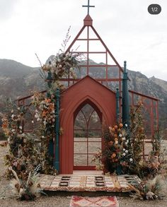 an outdoor altar with flowers and greenery on it