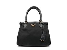 This Prada Women's Black Nylon Bauletto Handbag is luxurious and practical. There are three interior compartments with a zip divider, which is great for organizing and separating your personal belongings. The nylon material is durable and looks sleek with the black saffiano leather trim. The gold Prada Paris logo also goes beautifully with the black nylon. This designer bag is great for everyday use and can also be carried by the handles or adjustable  nylon strap. Includes authenticity cards an Elegant Top Handle Nylon Bags, Elegant Nylon Top Handle Bags, Elegant Nylon Shoulder Bag For Formal Occasions, Elegant Evening Nylon Bag, Elegant Formal Nylon Bag, Paris Logo, Medium Handbags, Personal Belongings, Designer Bag