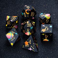 several black dices with numbers and stars on them