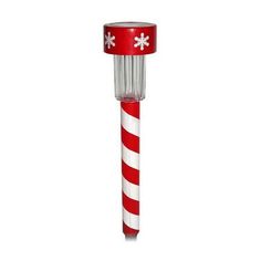 a red and white striped pole with snowflakes on it's top, in front of a white background