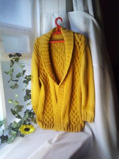 "Hand-knitted mustard men's or women's cardigans. Shawl V Neck, long sleeve, Size Extra Large. Yellow unisex soft wool Jacket.   I will fulfill the order according to your measurements. Sample dimensions:     Chest circumference up to 120cm(47\" inches), length of the cardigan 80cm(31.5\"), sleeve length 65cm(25.6\"). Soft voluminous cardigan.  There is a belt.  At will, I can make buttons or press buttons on the female or male side. Washing delicately." Yellow Knitted Long Sleeve Cardigan, Yellow Long Cardigan For Fall, Long Yellow Fall Cardigan, Oversized Yellow Knit Cardigan, Oversized Yellow Winter Cardigan, Oversized Yellow Cardigan For Winter, Yellow Knitted Winter Cardigan, Yellow Knit Long Sleeve Outerwear, Yellow Winter Cardigan