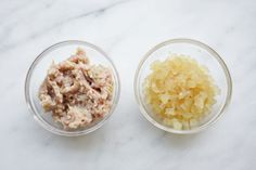 two bowls filled with food sitting on top of a white counter next to each other