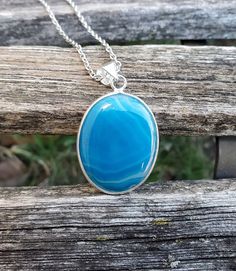 "This gorgeous necklace is perfect for anyone! It has a large pendant of blue banded agate in a silver base. The pendant measures 1 1/2\" long x just over 1\" wide. Total pendant length is 1 7/8\". Choose your necklace length at checkout. All jewelry items come in a gift box. These would be great for any time of the year! Perfect for a wedding, for a Christmas gift, anniversary gift, for Mother's Day, or a birthday. Please let me know if you have any questions. #n331" Blue Chalcedony Spiritual Necklace, Blue Oval Agate Jewelry, Oval Blue Agate Jewelry, Blue Cabochon Necklace For Gift, Blue Cabochon Necklace For Gifts, Turquoise Chalcedony Necklace For Gift, Blue Oval Pendant Necklace With Spiritual Style, Chalcedony Necklace With Large Pendant For Gift, Oval Chalcedony Necklace As Gift