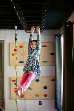 There’s nothing quite like indoor monkey bars in a playroom! We love how these playroom climbing walls are set up to work with the indoor monkey bars for kids. A perfect playroom setup!  Photo by Steph Hampton Diy Rock Wall For Kids, Diy Rock Wall, Monkey Bars For Kids, Playroom Climbing Wall, Playroom Climbing, Playroom Setup, Indoor Climbing Holds, Indoor Monkey Bars, Basement Kids