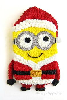 a cake made to look like a minion with glasses and a santa hat on