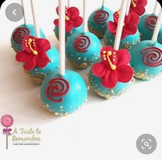 blue cake pops with red flowers on them