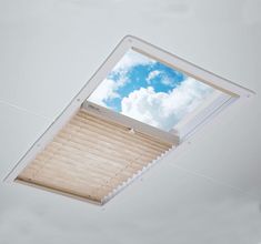 an overhead view of a skylight with blinds on the bottom and ceiling in front