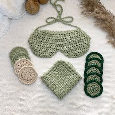 crocheted items are laid out on a white surface, including a pair of slippers