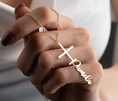 "Cross Name Necklace The name cross necklace is a beautiful and personalized piece of jewelry that combines the timeless symbol of Christianity with the wearer's name or initials. It is a perfect religious gift for special occasions such as baptisms, confirmations, and weddings. For mothers who wish to keep their faith close to their hearts, the name cross necklace can be a thoughtful and meaningful gift. It serves as a daily reminder of the love that God has for their family and the importance Personalized Cross Necklace In Gold, Customizable Gold Cross Jewelry, Personalized Gold Cross Necklace, Customizable Cross Pendant Jewelry As Gift, Customizable Cross Pendant Jewelry For Gifts, Customizable Cross Pendant Jewelry Gift, Personalized 14k Gold Cross Jewelry, Personalized Gold Cross Jewelry, Elegant Personalized Cross Necklace For Anniversary