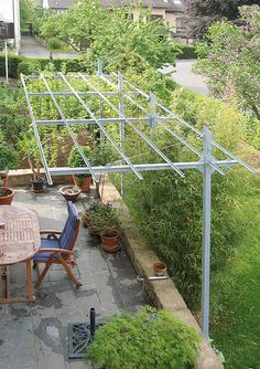 an outdoor dining area with several potted plants