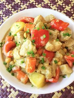 a white bowl filled with vegetables on top of a table