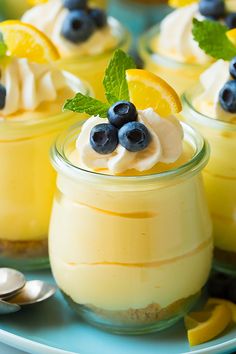 two pictures of desserts with lemon and blueberries in them, one is topped with whipped cream