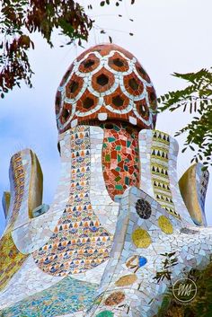 an artisticly designed building with lots of different colors and designs on it's side