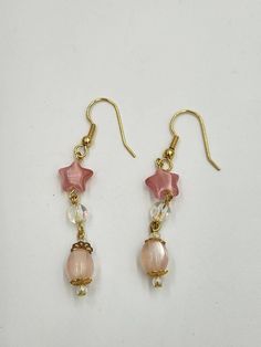 Light weight earrings with all the movement you enjoy in a dangle earring. The star bead is glass and supports a lucite aurora bread and a pale pink oblong bead. Total length is 2.5 inches. Pink Star Earrings For Party, Pink Crystal Dangle Earrings With Ear Wire, Pink Star-shaped Party Earrings, Pink Star Charm Dangle Earrings, Pink Dangle Earrings With Star Charm, Crafts 2024, Earring Inspo, Forest Grove, Diy Jewelry Earrings