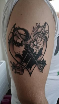 a man with a tattoo on his arm holding a knife in the shape of a heart