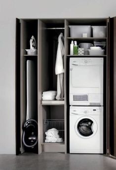 a washer and dryer sitting in a closet next to each other on shelves