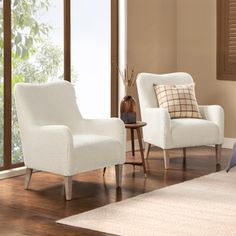 a living room with two white chairs in it