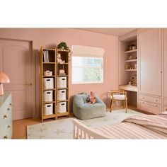 a child's bedroom with pink walls and furniture