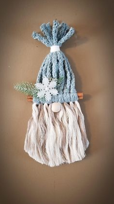 a blue and white knitted hat hanging on a wall