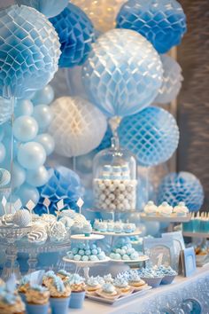 a table topped with blue and white desserts