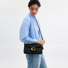 A modern take on an archival 1970s Coach design our structured Tabby shoulder bag is crafted of polished pebble leather. Finished with our Signature hardware for an iconic touch the compact 26 features two detachable straps to carry by hand style as a short shoulder bag or wear crossbody. | Coach Tabby Shoulder Bag 26 - Women's - Brass/black Modern Coach Satchel With Gold-tone Hardware, Coach Flap Bag With Detachable Strap, Chic Everyday Flap Bag With Branded Hardware, Modern Coach Flap Shoulder Bag, Classic Double Flap Bag With Branded Hardware, Coach Shoulder Bag With Detachable Strap For Work, Classic Double Flap Shoulder Bag With Branded Hardware, Chic Double Flap Bag With Branded Hardware, Coach Shoulder Bag With Adjustable Strap For Work