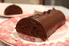 a piece of chocolate cake on a pink and white plate