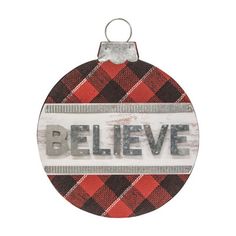 a red and black plaid ornament with the word believe in silver on it