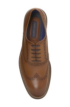 Stylish broguing lends vintage-inspired style to a polished leather oxford set atop a navy-blue rubber sole for slip-free strides. Leather upper/textile lining/rubber sole Imported Cognac Wingtip Oxfords With Leather Lining, Brown Leather Oxford Shoes For Business, Brown Oxford Shoes With Leather Sole And Round Toe, Classic Cognac Dress Shoes With Round Toe, Cognac Wingtip Leather Shoes For Business Casual, Cognac Wingtip Shoes For Business Casual, Business Casual Oxford Shoes With Leather Sole, Cognac Wingtip Oxfords With Leather Sole, Cognac Wingtip Oxfords For Work