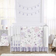 a baby crib bedding set with flowers on it