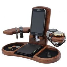 a cell phone is sitting on top of a wooden stand with other items around it