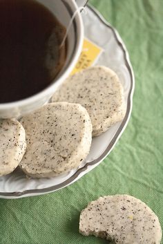 a cup of coffee and some cookies on a plate