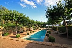 an outdoor swimming pool surrounded by trees and bushes