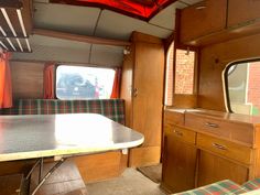 the inside of an rv with a table and television