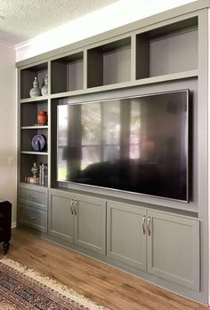 an entertainment center with built - in cabinets and a flat screen tv on the wall