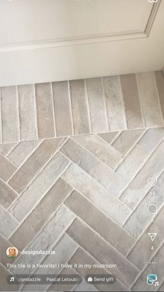 a tile floor with white and gray herringbones