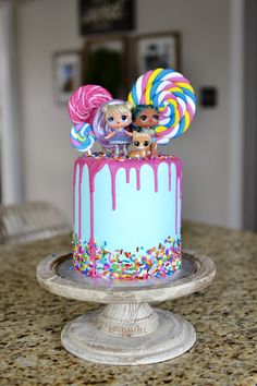 a birthday cake decorated with lollipops and candy