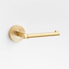 a gold door handle on a white wall