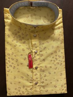 Raw Yellow Color Kurta Pajama in Self design material. Item : Men's Kurta Pajama Ready to Wear : Yes Kurta Color : Yellow Pajama Color : White Fabric : Raw Silk Pocket : Yes Disclaimer : Slight variation in actual color vs. image is possible due to the screen resolution. Yellow Kurta With Pallu For Puja, Unstitched Yellow Kurta For Puja, Yellow Kurta For Puja And Diwali, Festive Yellow Kurta For Puja, Yellow Traditional Wear With Patterns For Eid, Bollywood Style Festive Sherwani With Printed Motifs, Festive Bollywood Sherwani With Printed Motifs, Yellow Fitted Kurta For Puja, Yellow Bollywood Kurta With Traditional Patterns