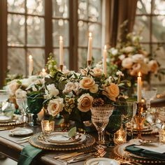 the table is set with flowers and candles